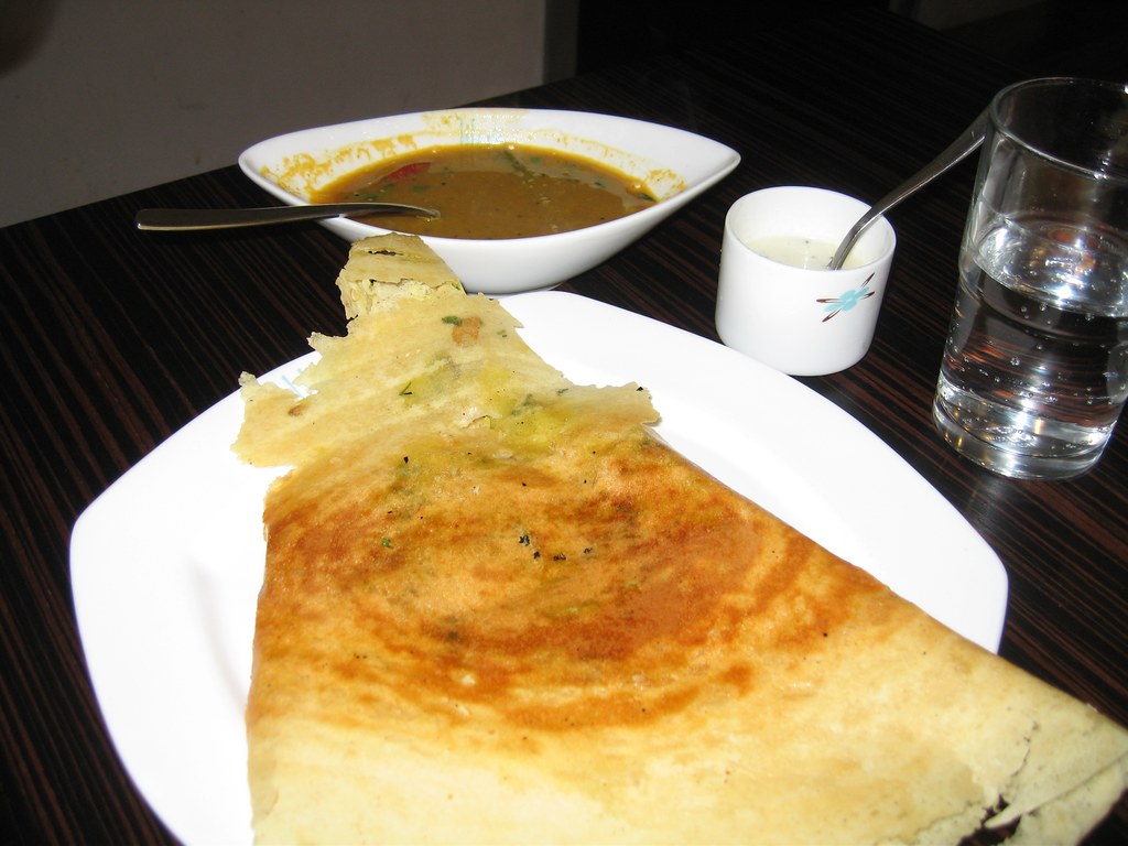 A crisp golden dosa folded on a plate